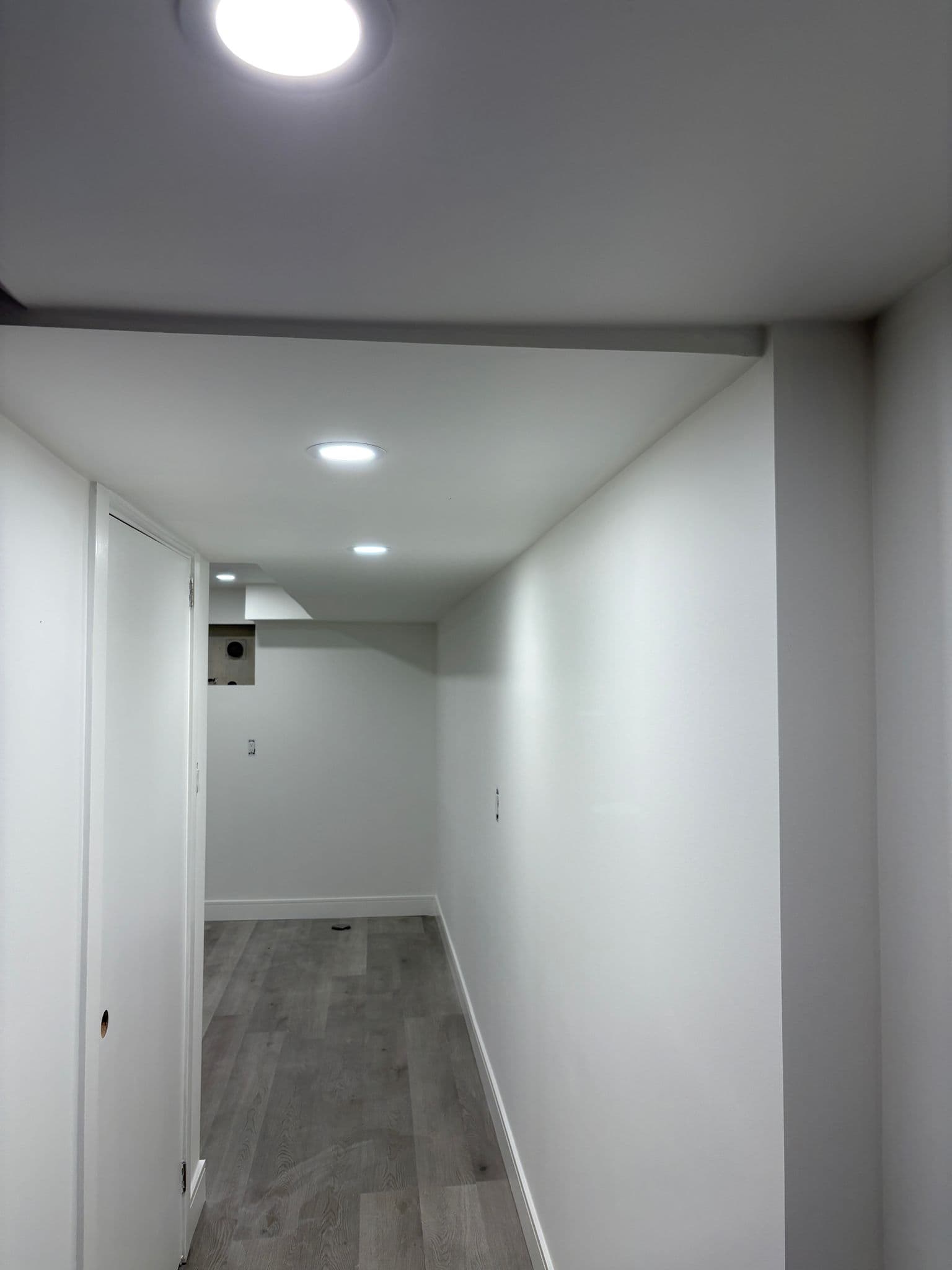 Lower-level corridor, lighting, and flooring